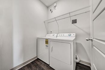 A white washer and dryer in a laundry room.
